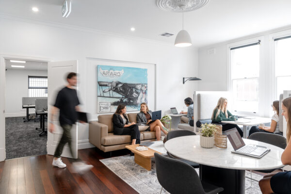 Staff members working in the shared coworking space at Kaizen West in West Perth coworking space.