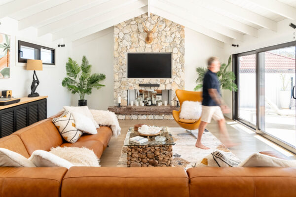 The Resort commercial property in Kinross WA, featuring modern design and a man walking through the living room